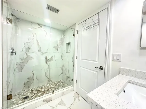 a bathroom with a sink mirror vanity and toilet
