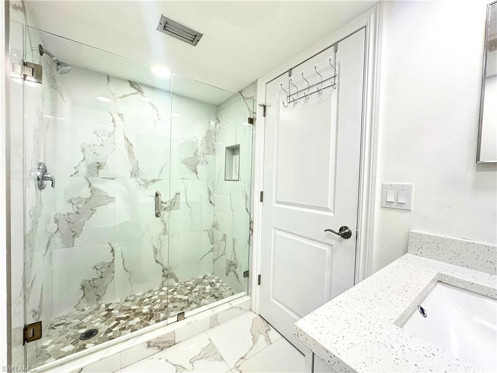 Undisclosed Address Naples, FL 34116 - Photo 13 of 16 a bathroom with a shower and a sink