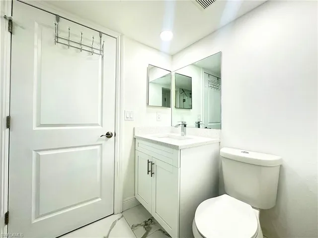 a room with a stove and a refrigerator