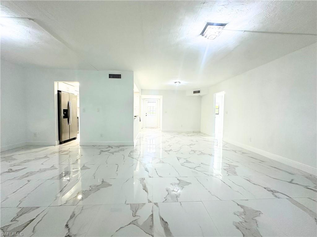 Undisclosed Address Naples, FL 34116 - Photo 4 of 16 a view of a bathroom with a sink and a shower