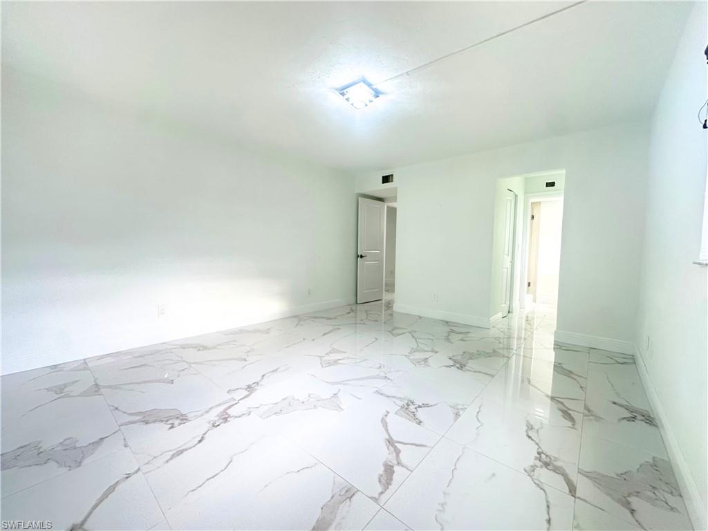 Undisclosed Address Naples, FL 34116 - Photo 8 of 16 an empty room with a bathroom