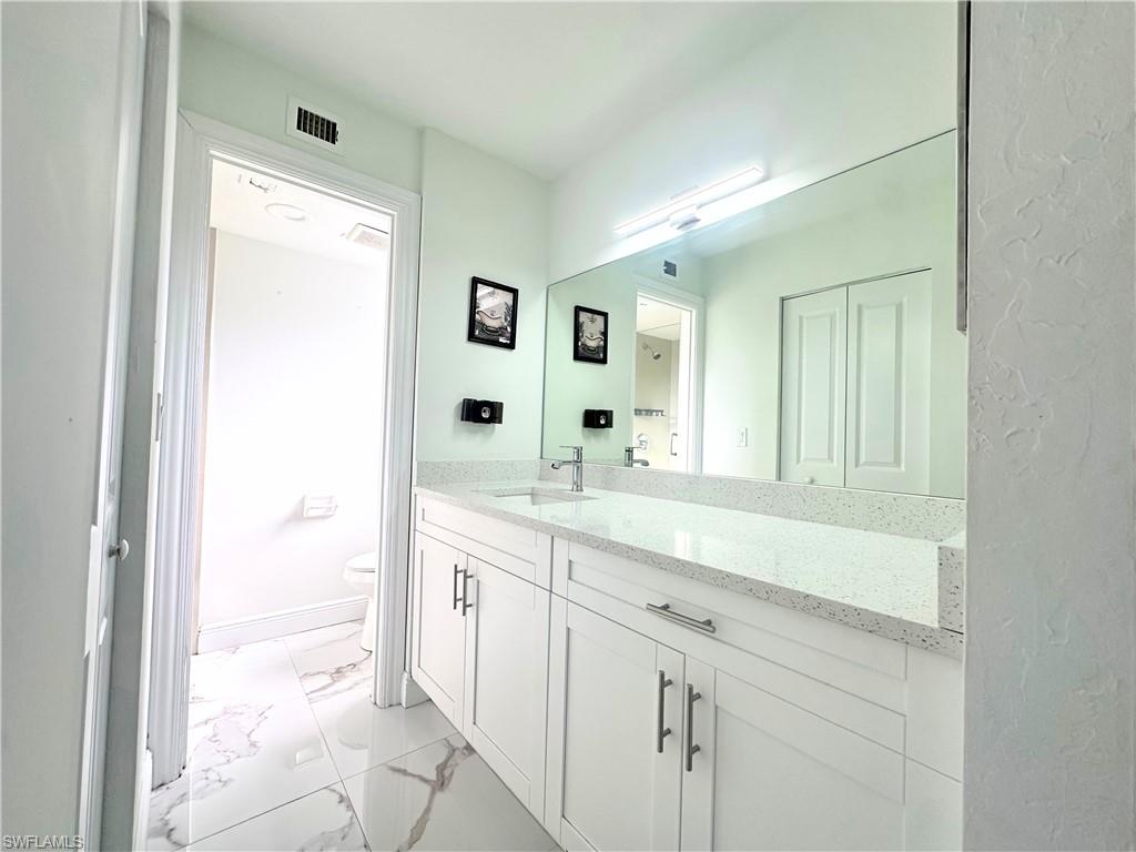 Undisclosed Address Naples, FL 34116 - Photo 9 of 16 a bathroom with a sink and a mirror