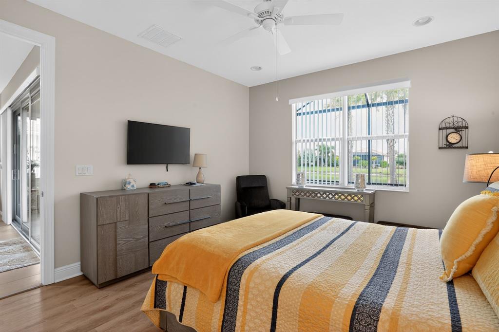 21044 Southwest Modena Way Port St. Lucie, FL 34986 - Photo 19 of 42 a bedroom with a bed and a flat screen tv