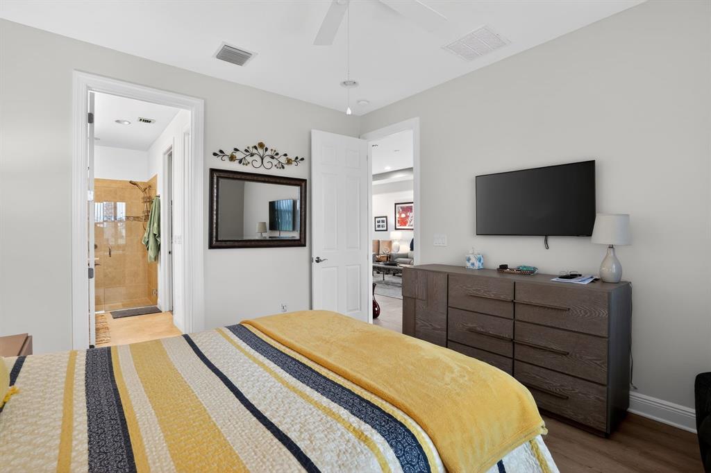 21044 Southwest Modena Way Port St. Lucie, FL 34986 - Photo 21 of 42 a bedroom with a bed and a flat tv screen on dresser