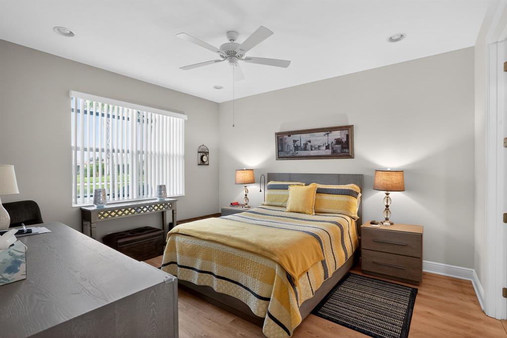 21044 Southwest Modena Way Port St. Lucie, FL 34986 - Photo 22 of 42 a bedroom with two beds and a large window