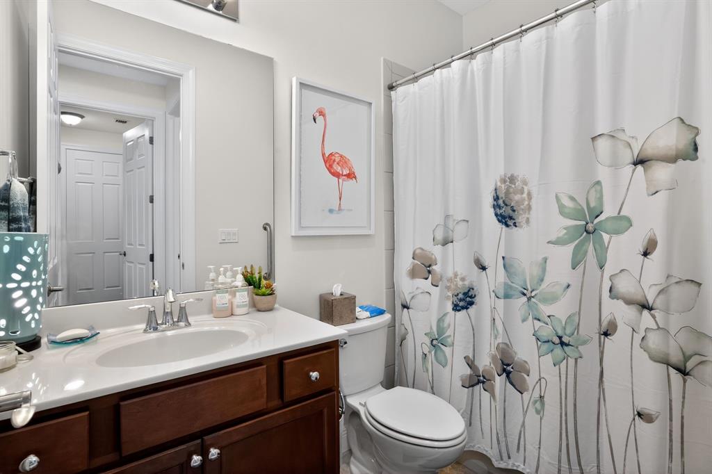 21044 Southwest Modena Way Port St. Lucie, FL 34986 - Photo 23 of 42 a bathroom with a sink a toilet and shower curtain