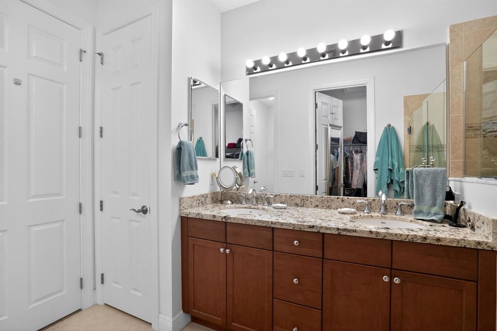 21044 Southwest Modena Way Port St. Lucie, FL 34986 - Photo 28 of 42 a bathroom with a granite countertop sink and a mirror