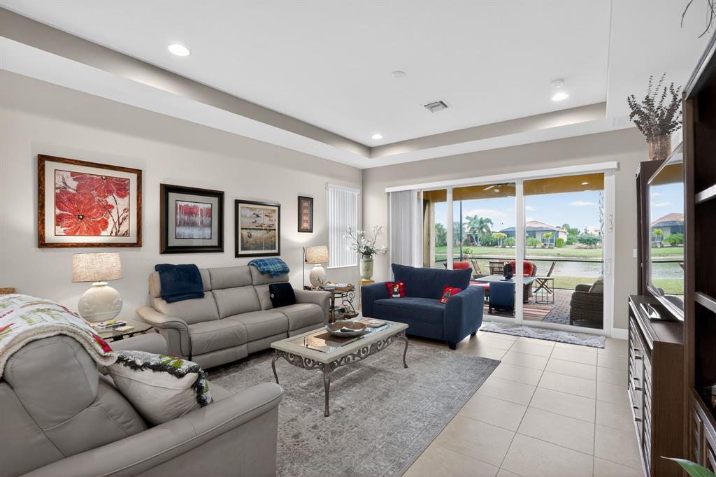 21044 Southwest Modena Way Port St. Lucie, FL 34986 - Photo 10 of 42 a living room with furniture tv and a large window