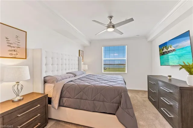 a bedroom with a large bed and a potted plant