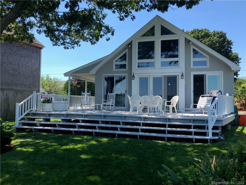a front view of house with a garden and patio