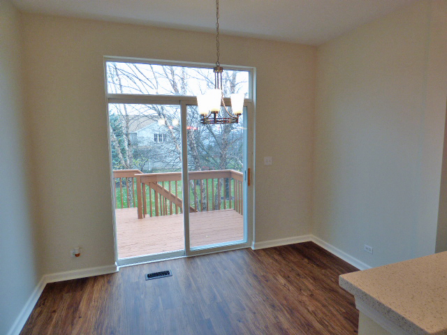 267 Grand Ridge Road St. Charles, IL 60175 - Photo 15 of 41 a view of an empty room with wooden floor and a window
