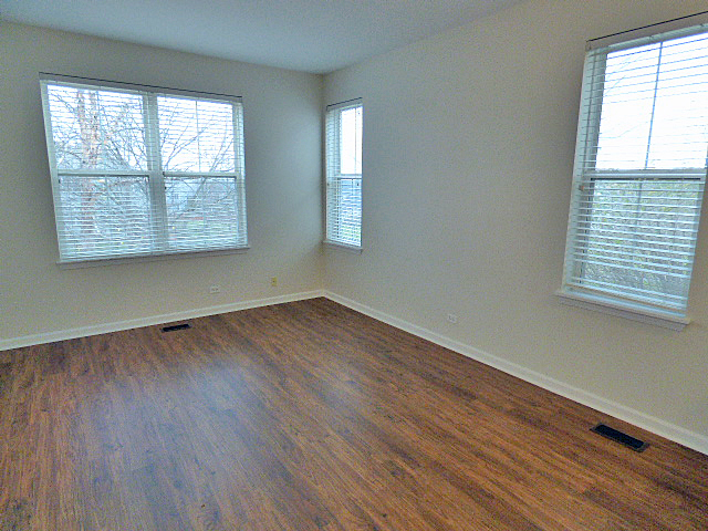 267 Grand Ridge Road St. Charles, IL 60175 - Photo 6 of 41 an empty room with wooden floor and windows