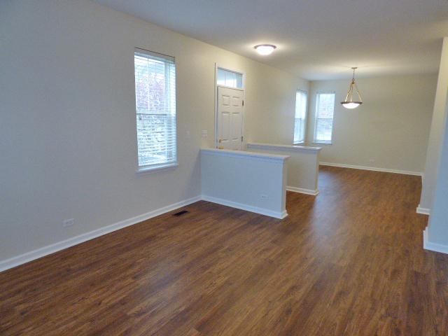 267 Grand Ridge Road St. Charles, IL 60175 - Photo 8 of 41 an empty room with wooden floor and windows