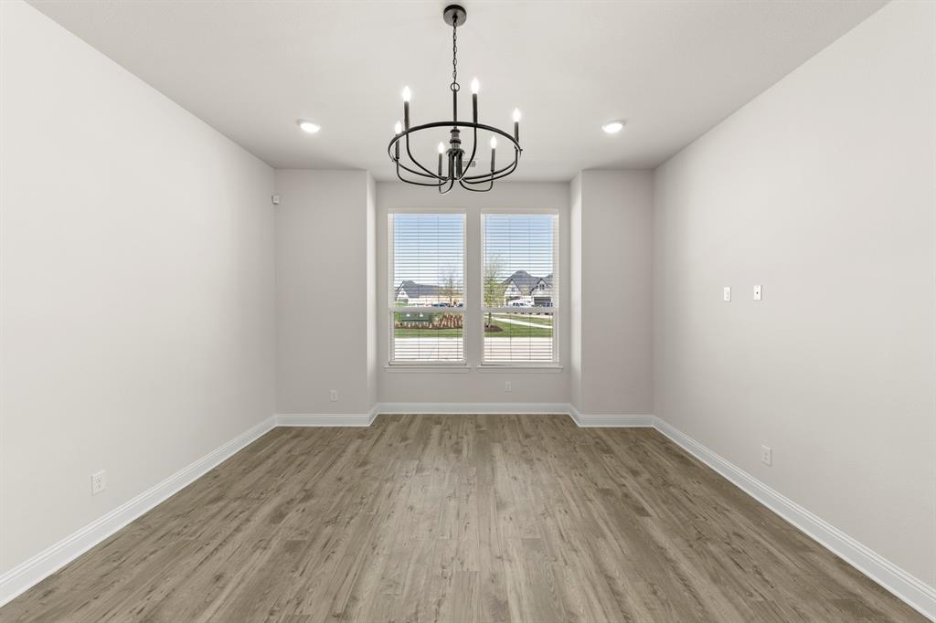 3900 Keya Drive Prosper, TX 75078 - Photo 17 of 36 a view of wooden floor and windows in a room
