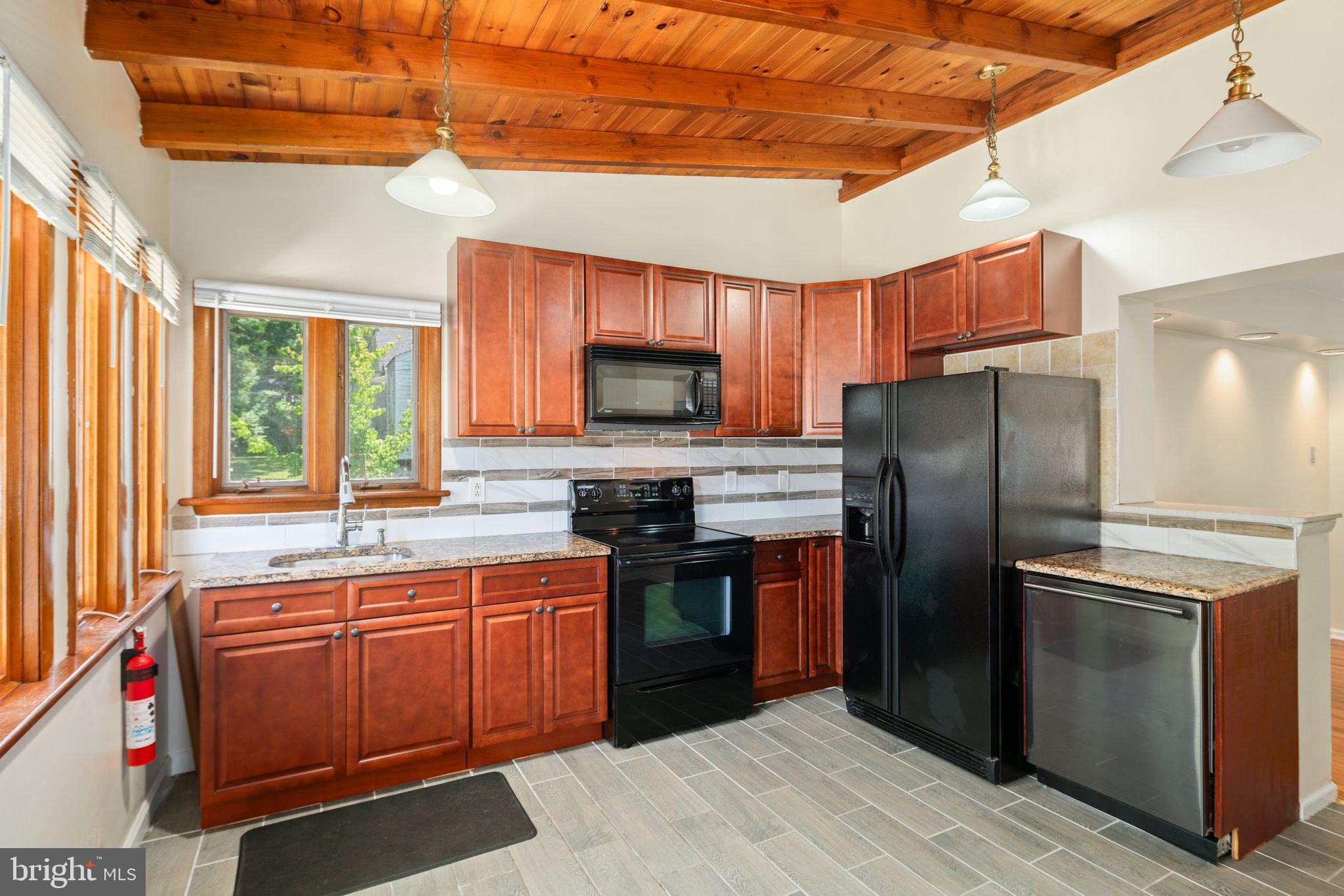 13 Rodney Road Bryn Mawr, PA 19010 - Photo 12 of 42 a kitchen with stainless steel appliances granite countertop a stove a refrigerator and a sink