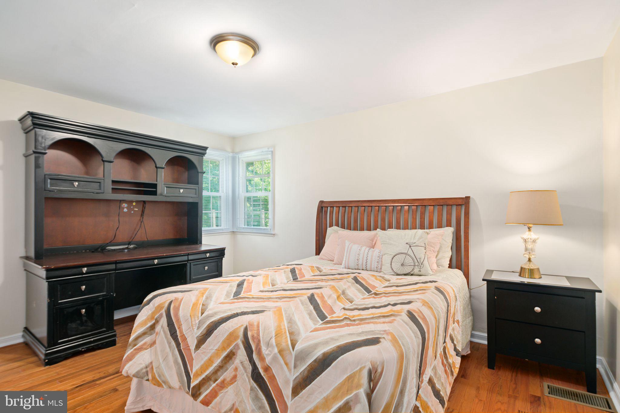 13 Rodney Road Bryn Mawr, PA 19010 - Photo 16 of 42 a bedroom with a bed and a flat tv screen on dresser