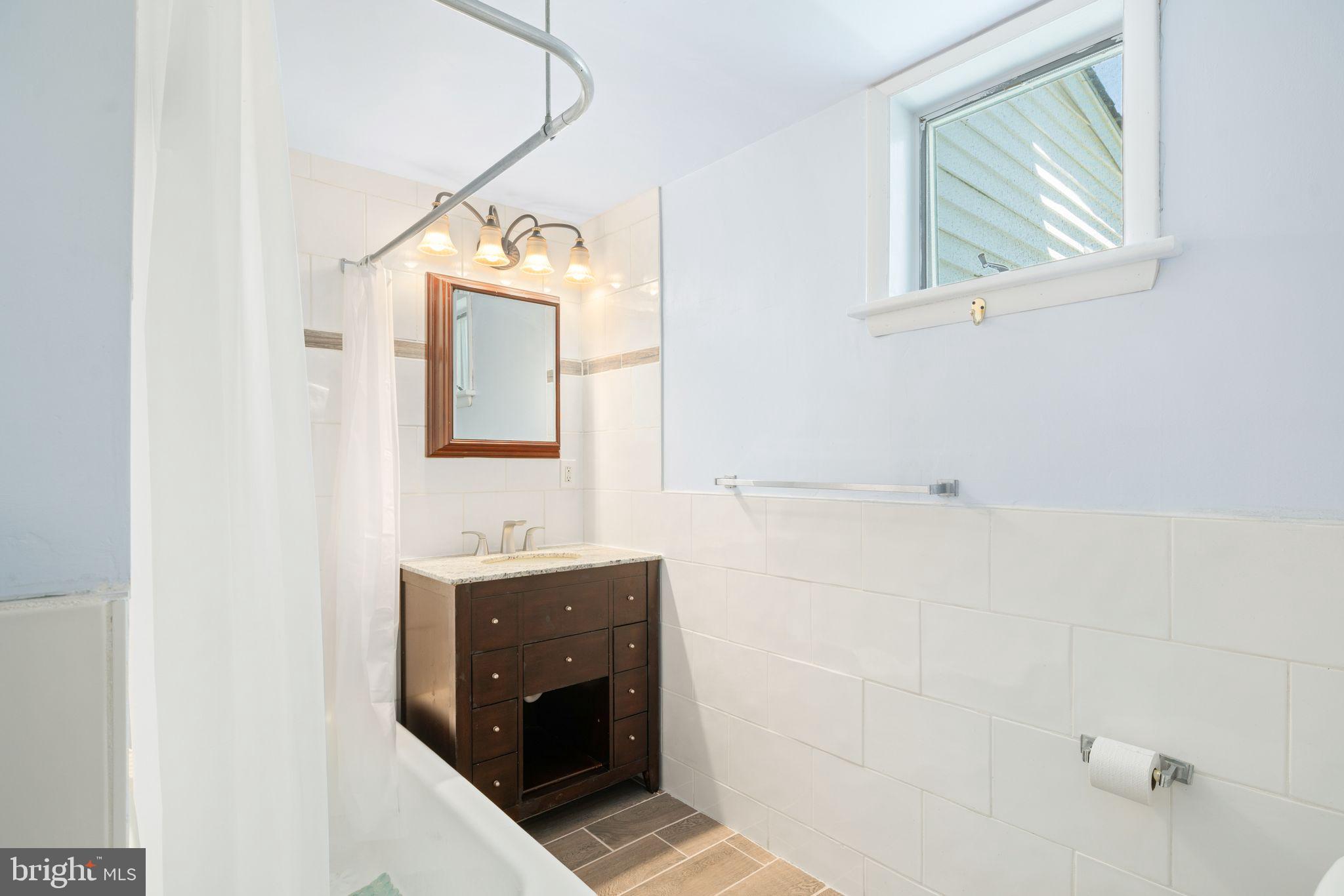 13 Rodney Road Bryn Mawr, PA 19010 - Photo 19 of 42 a bathroom with a sink and a mirror
