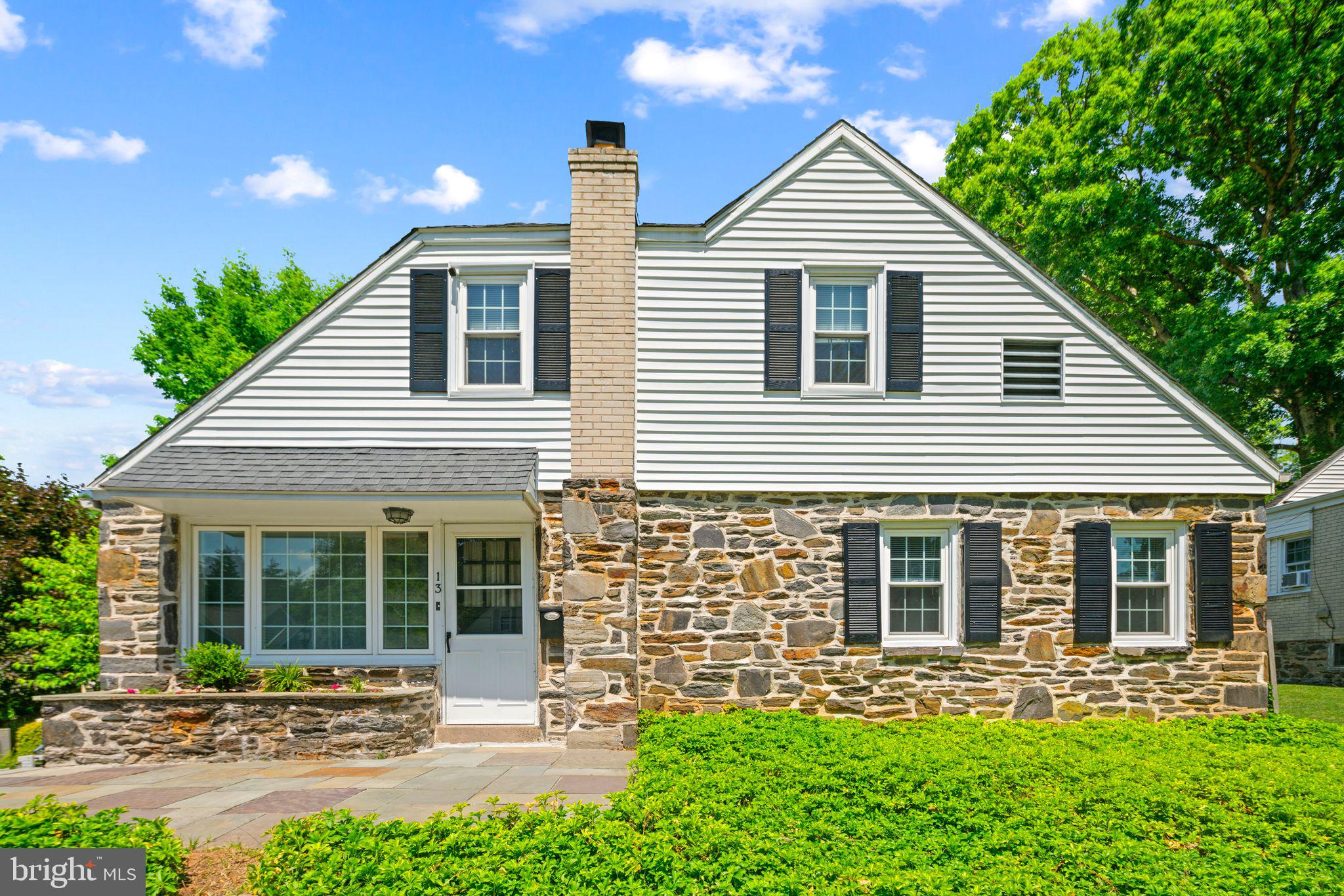13 Rodney Road Bryn Mawr, PA 19010 - Photo 2 of 42 a front view of a house with a garden and plants
