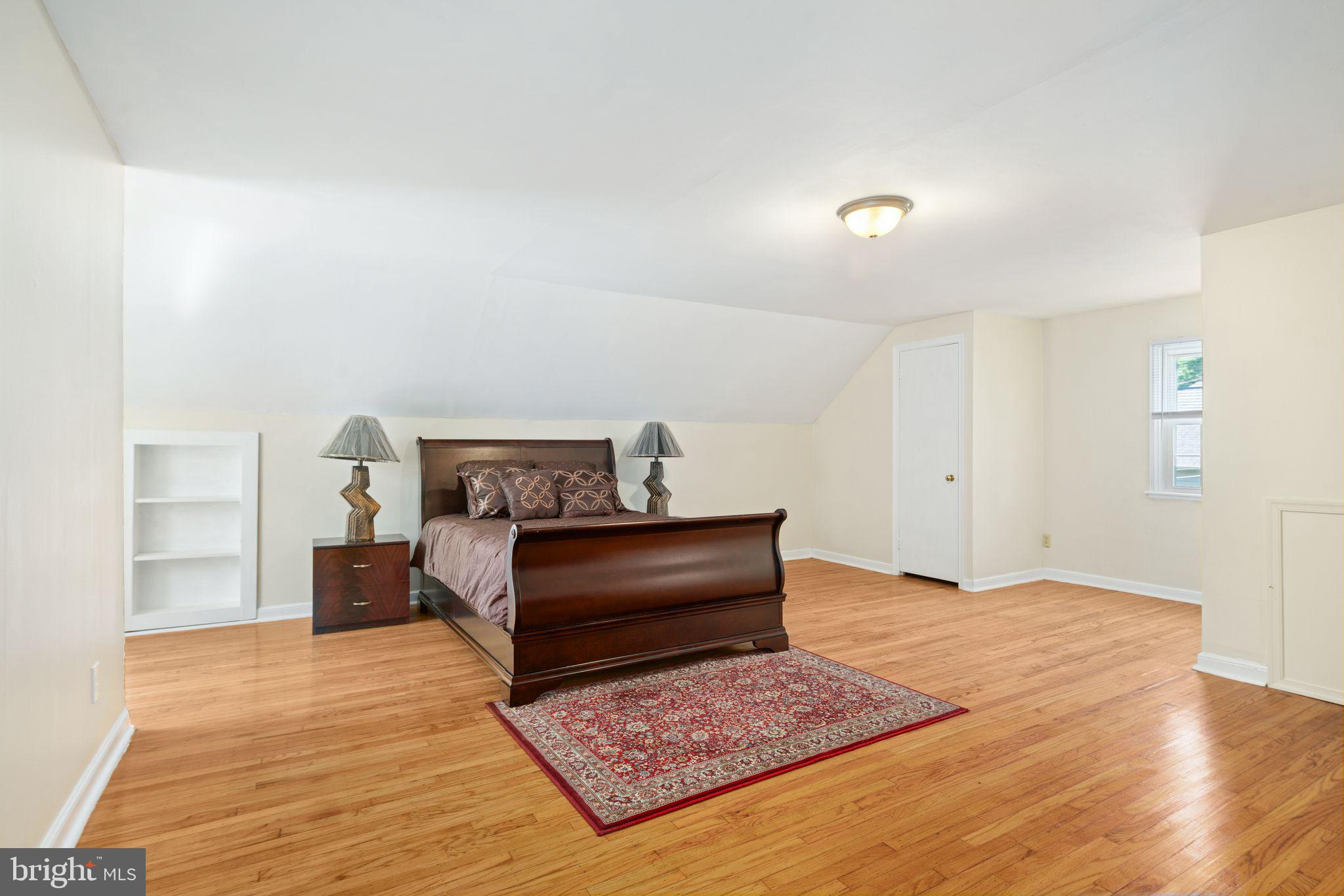 13 Rodney Road Bryn Mawr, PA 19010 - Photo 23 of 42 a bedroom with a bed and wooden floor