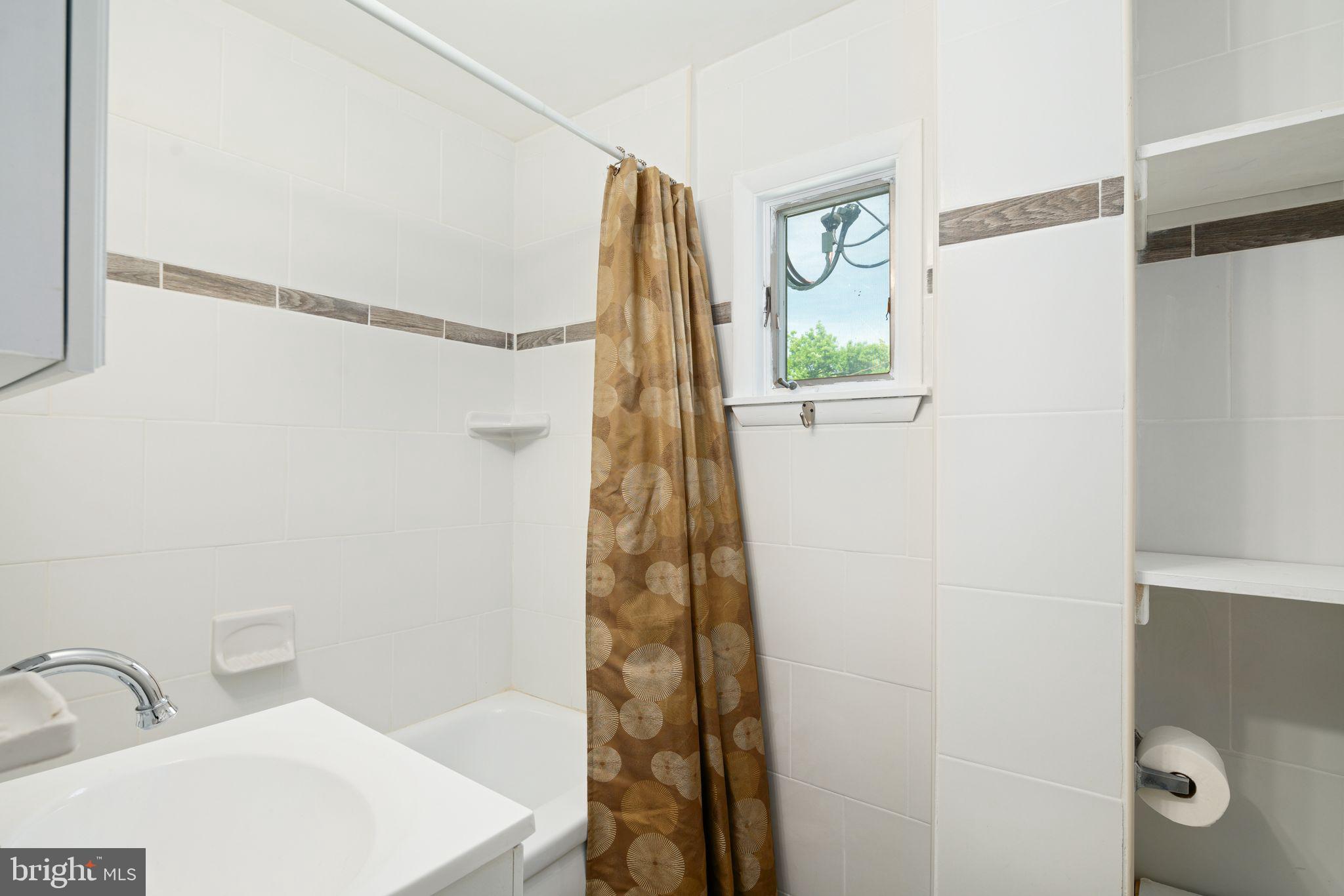 13 Rodney Road Bryn Mawr, PA 19010 - Photo 27 of 42 a bathroom with a shower and a sink