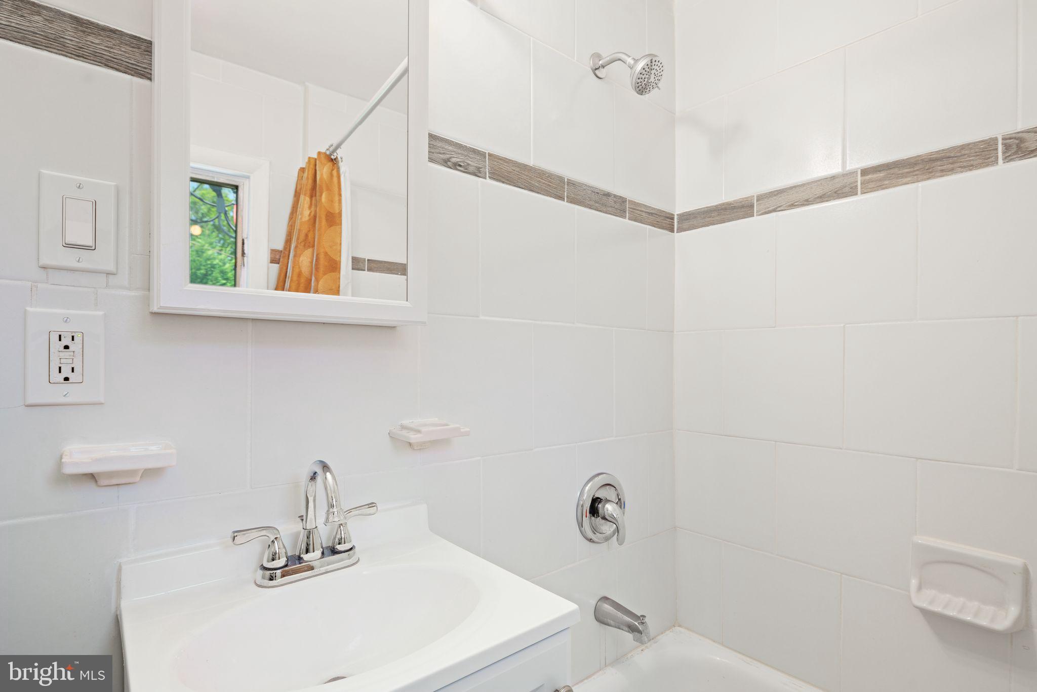 13 Rodney Road Bryn Mawr, PA 19010 - Photo 28 of 42 a bathroom with a sink a mirror and a shower