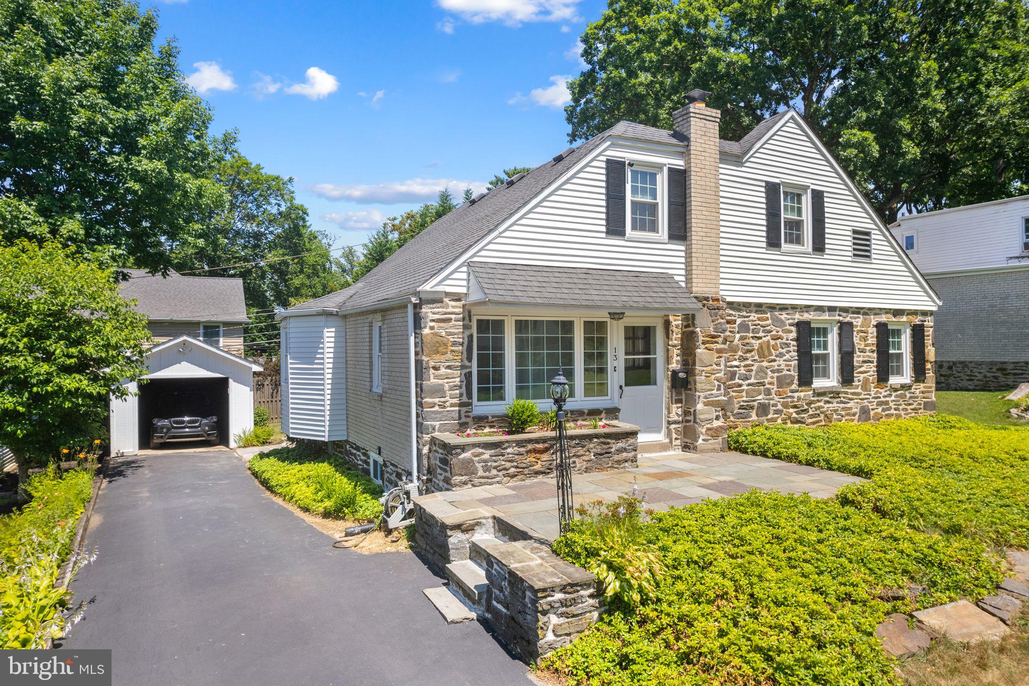13 Rodney Road Bryn Mawr, PA 19010 - Photo 3 of 42 front view of a house with a patio