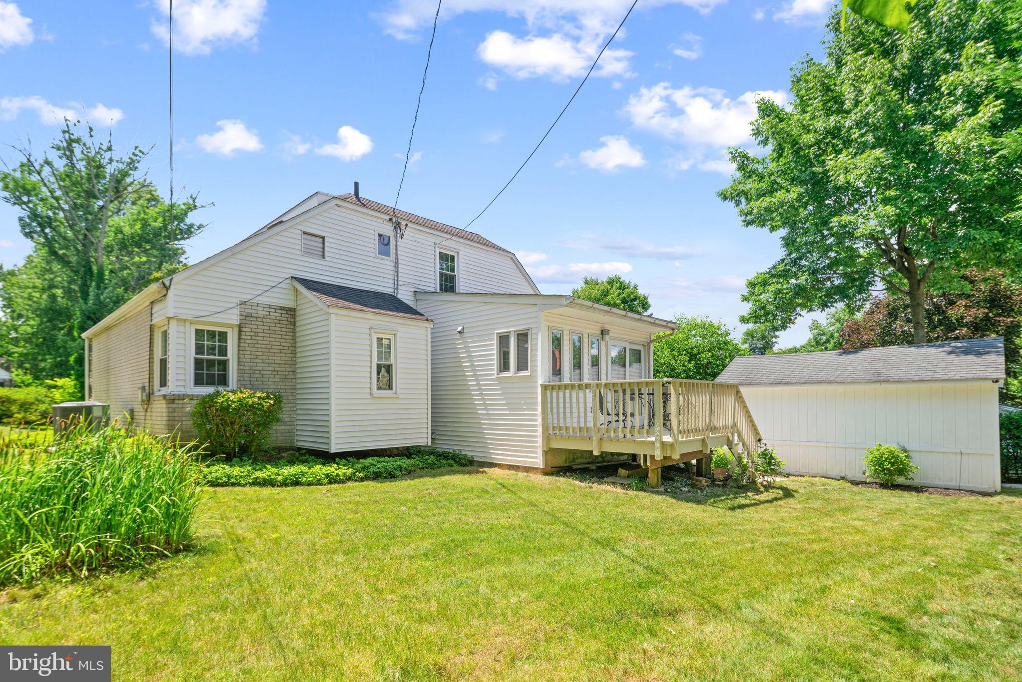 13 Rodney Road Bryn Mawr, PA 19010 - Photo 31 of 42 a front view of house with yard and trees in the background