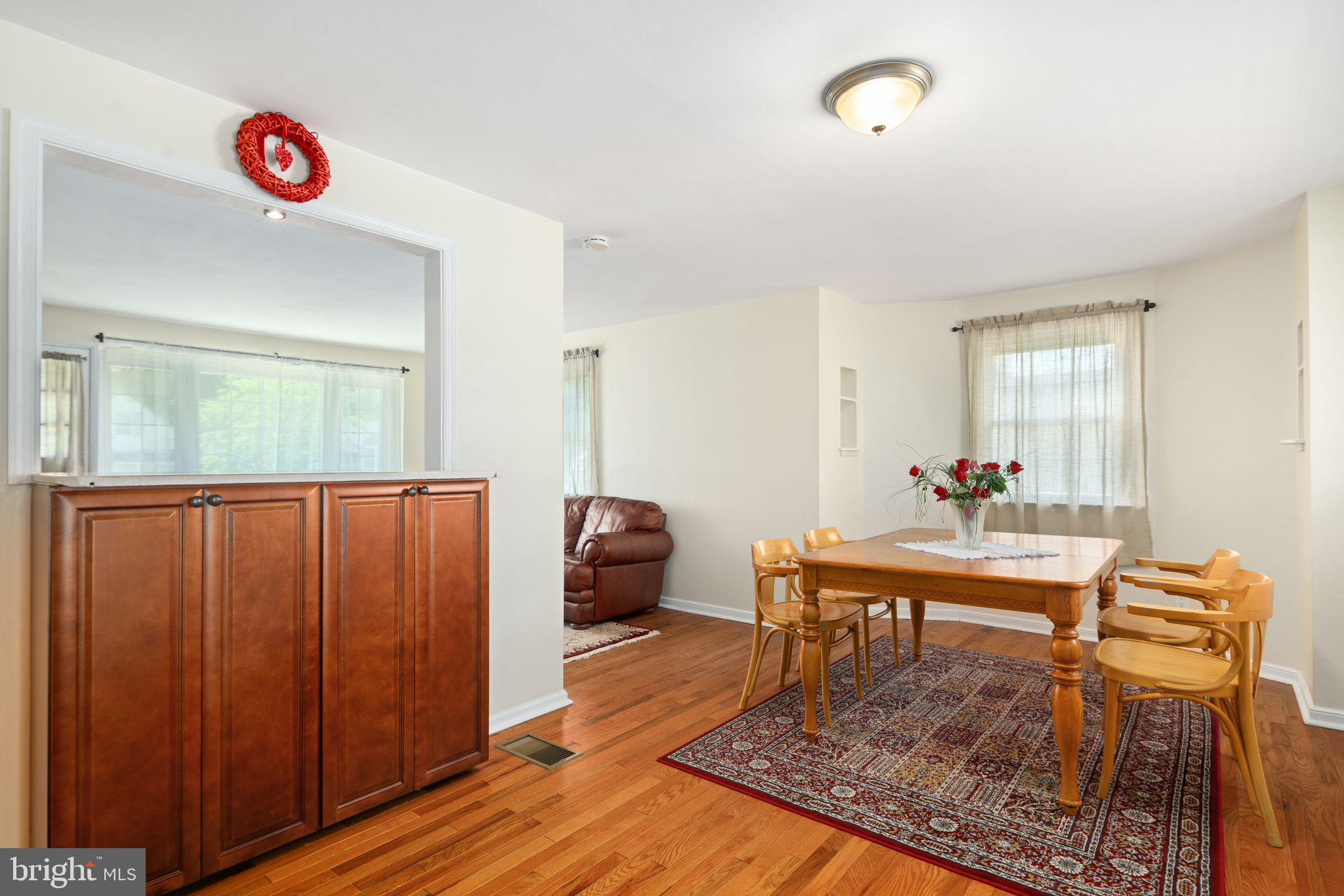 13 Rodney Road Bryn Mawr, PA 19010 - Photo 8 of 42 a living room with a couch and a bookshelf with wooden floor