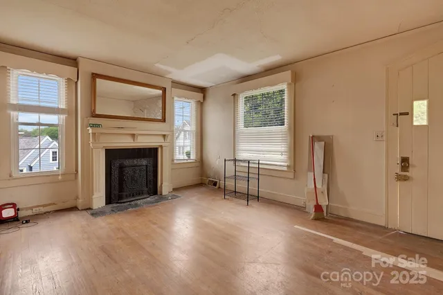 an empty room with furniture and a fireplace