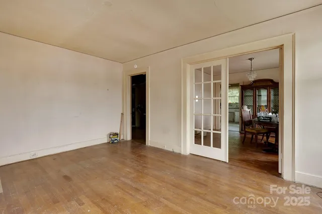 an empty room with furniture and a kitchen
