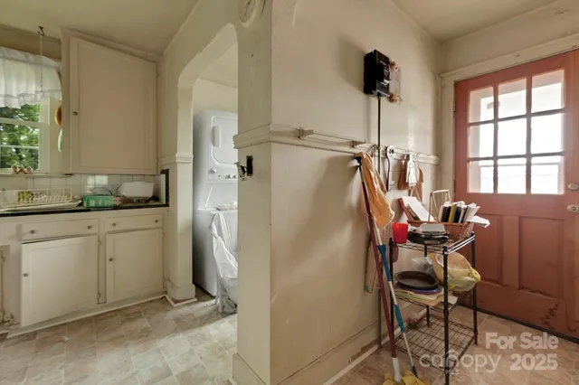 a kitchen with refrigerator and window
