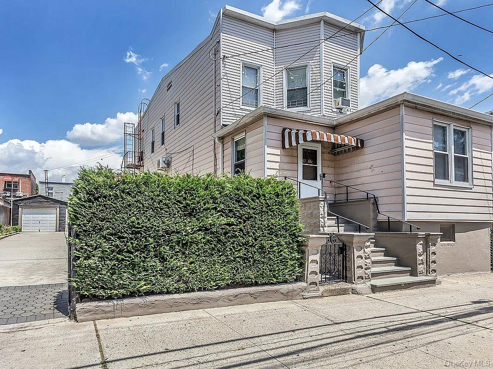 58-17 Penrod Street Queens, NY 11368 - Photo 1 of 15 a front view of a house with garden