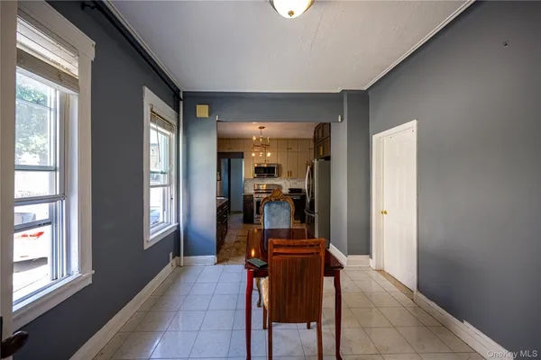 a view of a hallway with furniture and a window