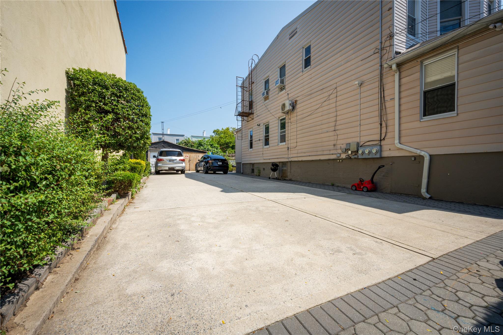 58-17 Penrod Street Queens, NY 11368 - Photo 8 of 15 a backyard of a house with yard and outdoor seating