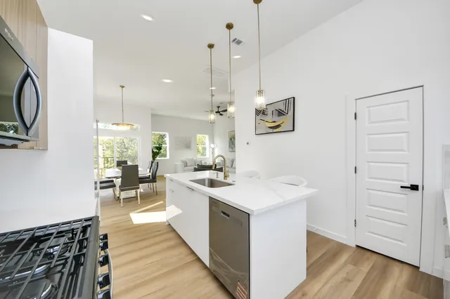 a view of a hallway with wooden floor and staircase