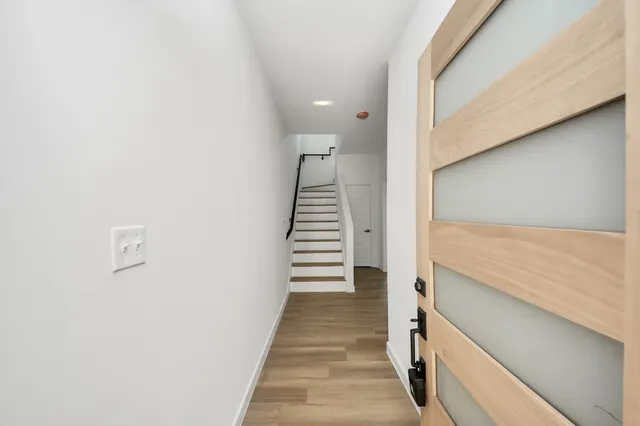 a view of a hallway with stairs