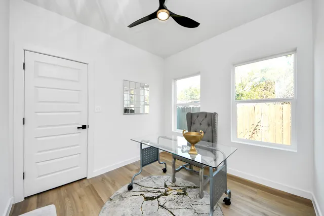 a workspace with wooden floor and a window