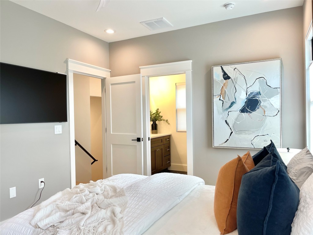 3405 Woodrow Street Austin, TX 78705 - Photo 11 of 13 a bedroom with a bed and a flat screen tv