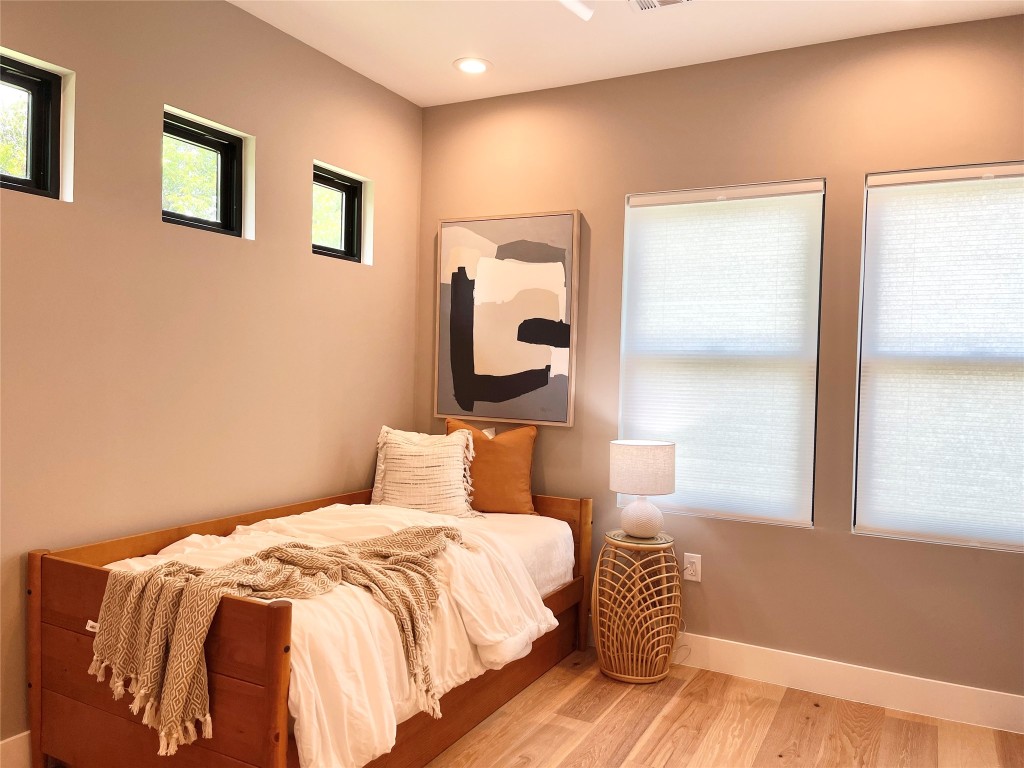 3405 Woodrow Street Austin, TX 78705 - Photo 12 of 13 a bedroom with a bed and a large window