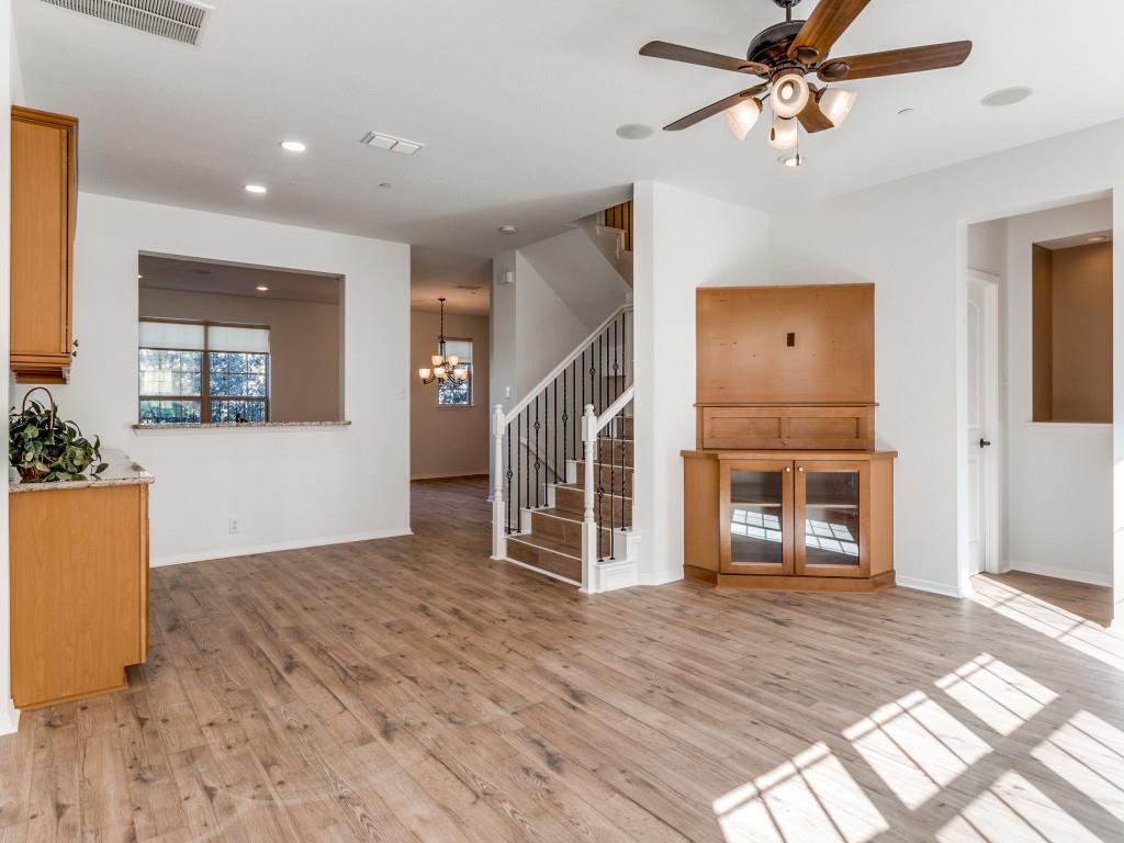 3942 Sugar Tree Way Addison, TX 75001 - Photo 14 of 31 a view of a livingroom with wooden floor and a ceiling fan