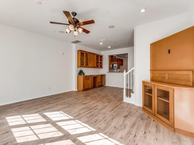 a view of hallway with wooden floor and stairs
