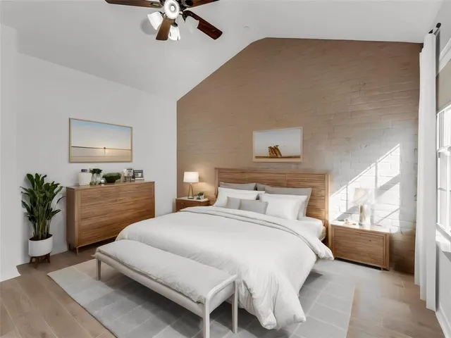 an empty room with windows and chandelier fan