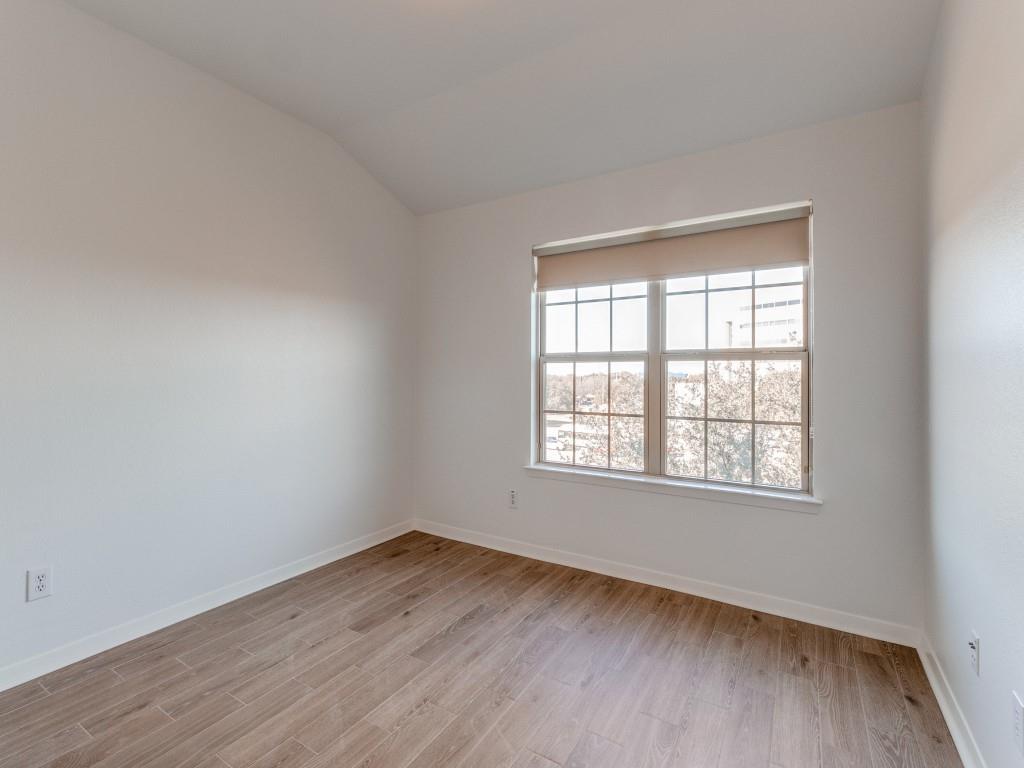 3942 Sugar Tree Way Addison, TX 75001 - Photo 29 of 31 an empty room with wooden floor and windows