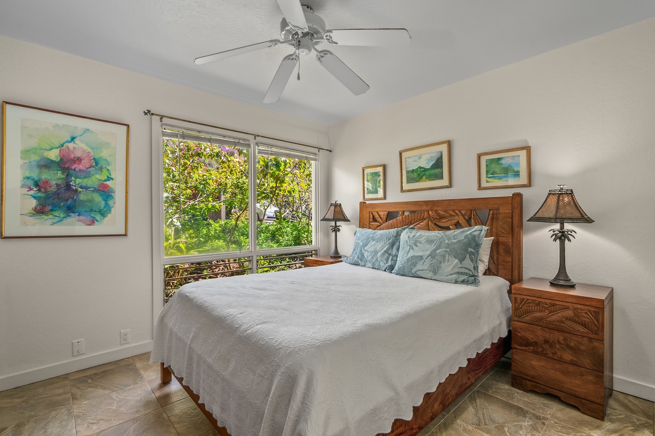 2330 Ho'ohu Road, Unit 5 Koloa, HI 96756 - Photo 16 of 28 a bedroom with a bed and a painting on the wall