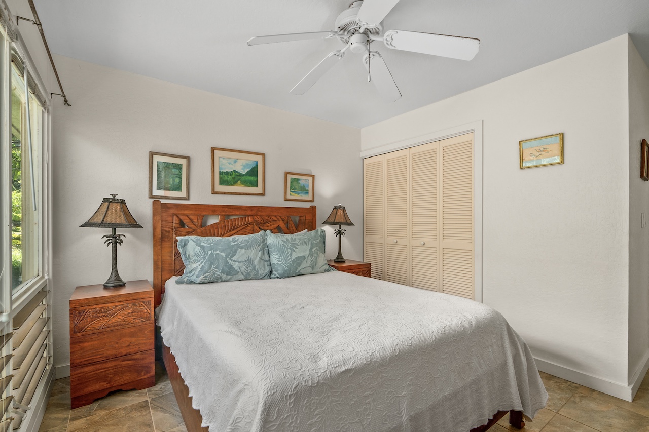2330 Ho'ohu Road, Unit 5 Koloa, HI 96756 - Photo 17 of 28 a bedroom with a bed and a chandelier