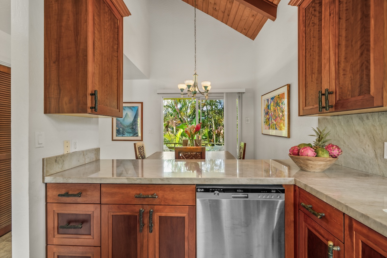 2330 Ho'ohu Road, Unit 5 Koloa, HI 96756 - Photo 7 of 28 a kitchen with stainless steel appliances granite countertop a sink a stove and a wooden cabinets