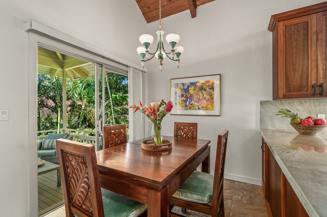 2330 Ho'ohu Road, Unit 5 Koloa, HI 96756 - Photo 9 of 28 a dining room with furniture a large window and a chandelier