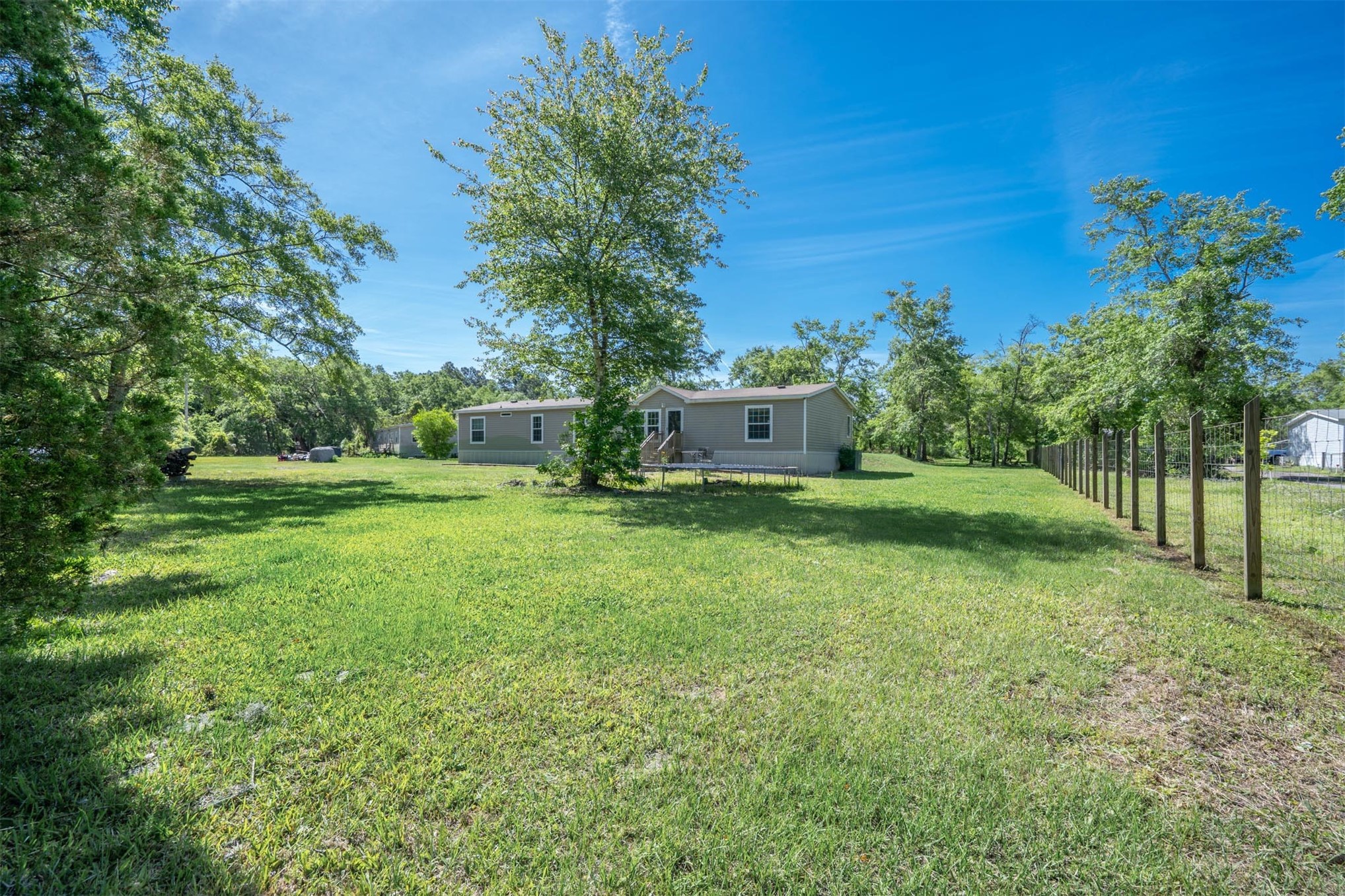 76220 Dove Road Yulee, FL 32097 - Photo 9 of 48 a view of a house with backyard and a tree