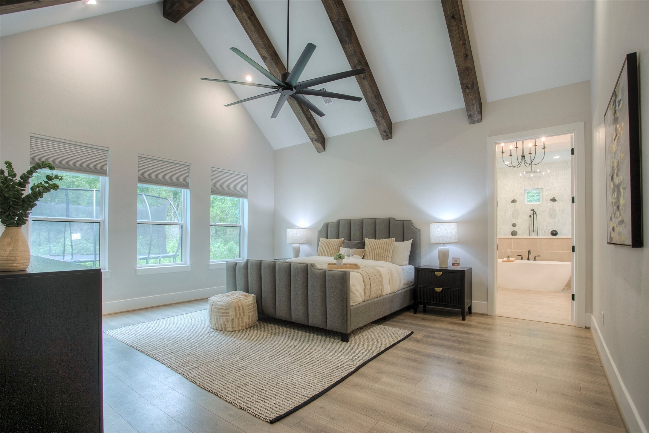 12915 Oak Barrel Road Willis, TX 77378 - Photo 19 of 46 The owners suite features a vaulted ceiling with wooden beams.