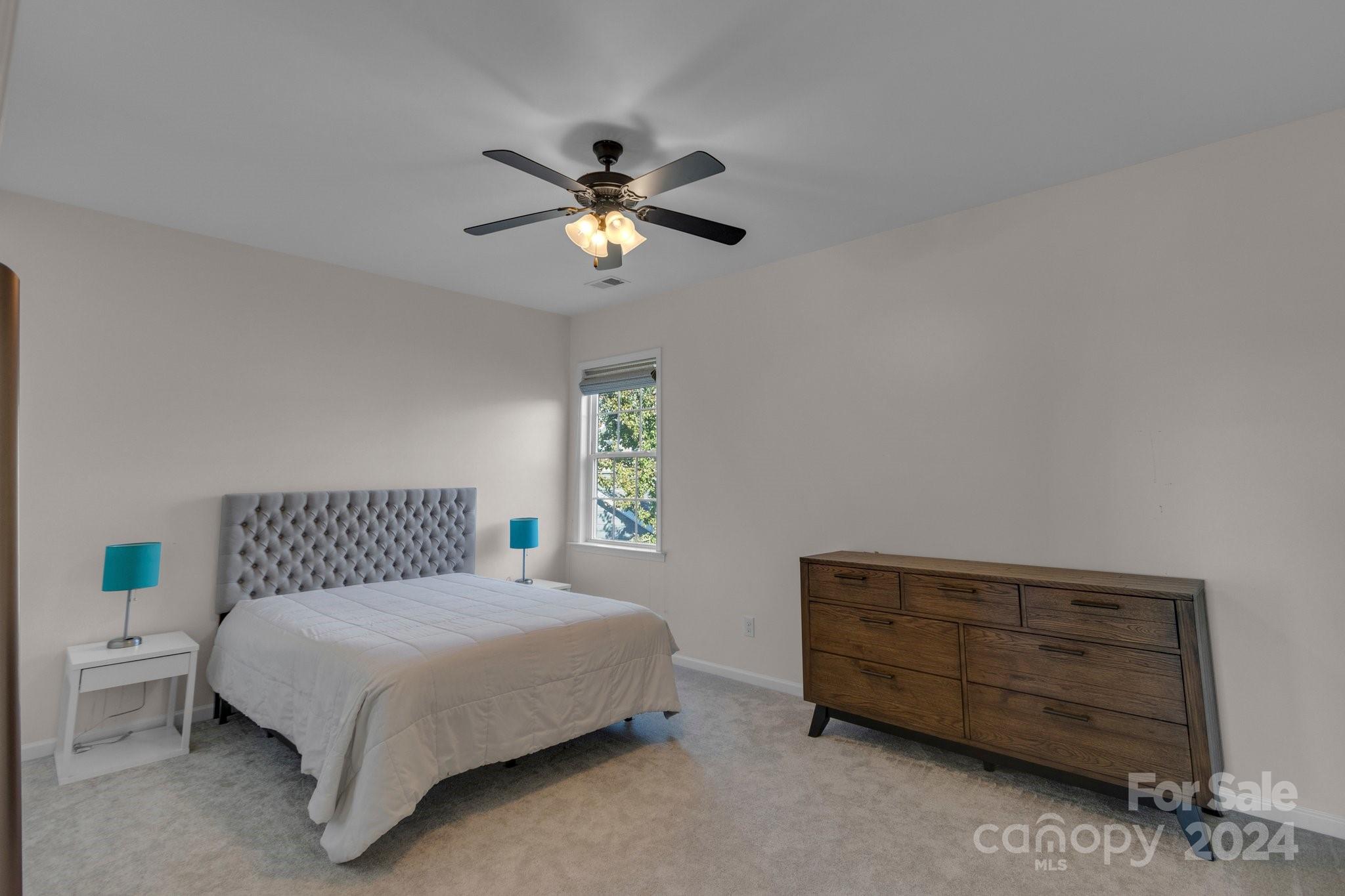 4095 Whittier Lane Fort Mill, SC 29708 - Photo 15 of 30 a bedroom with a bed and a chandelier
